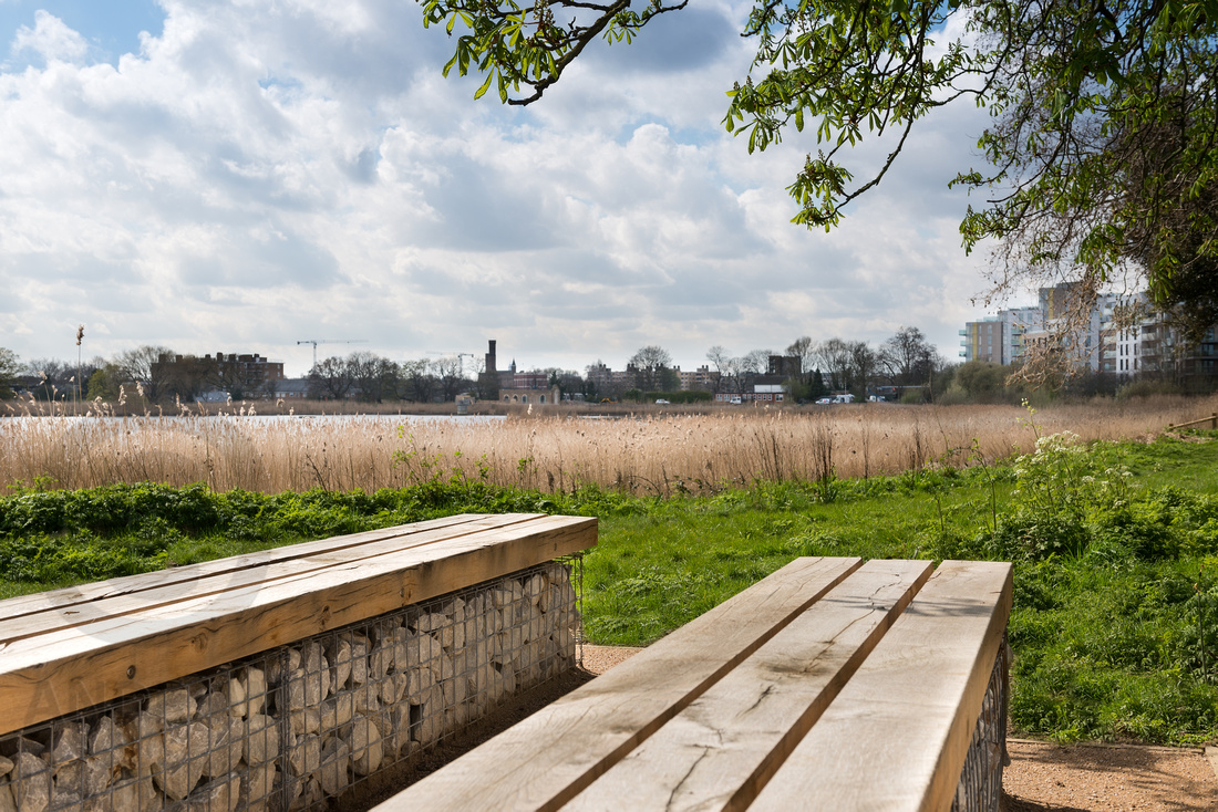 View west across the Woodberry Wetlands reservoir with the new Coal House Café in the background 