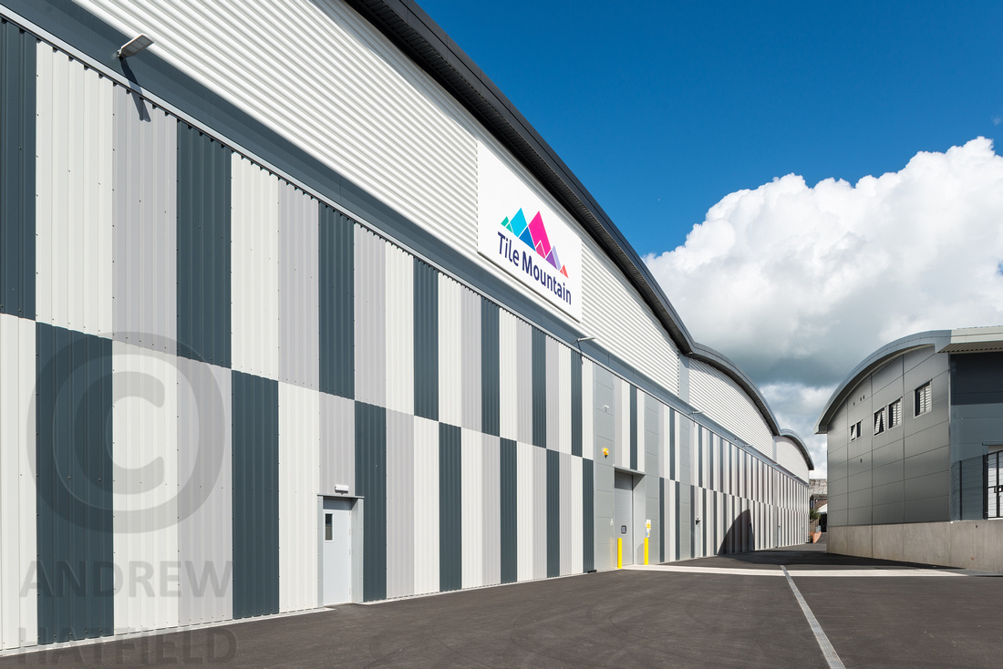 Large industrial warehouse with blue sky background 