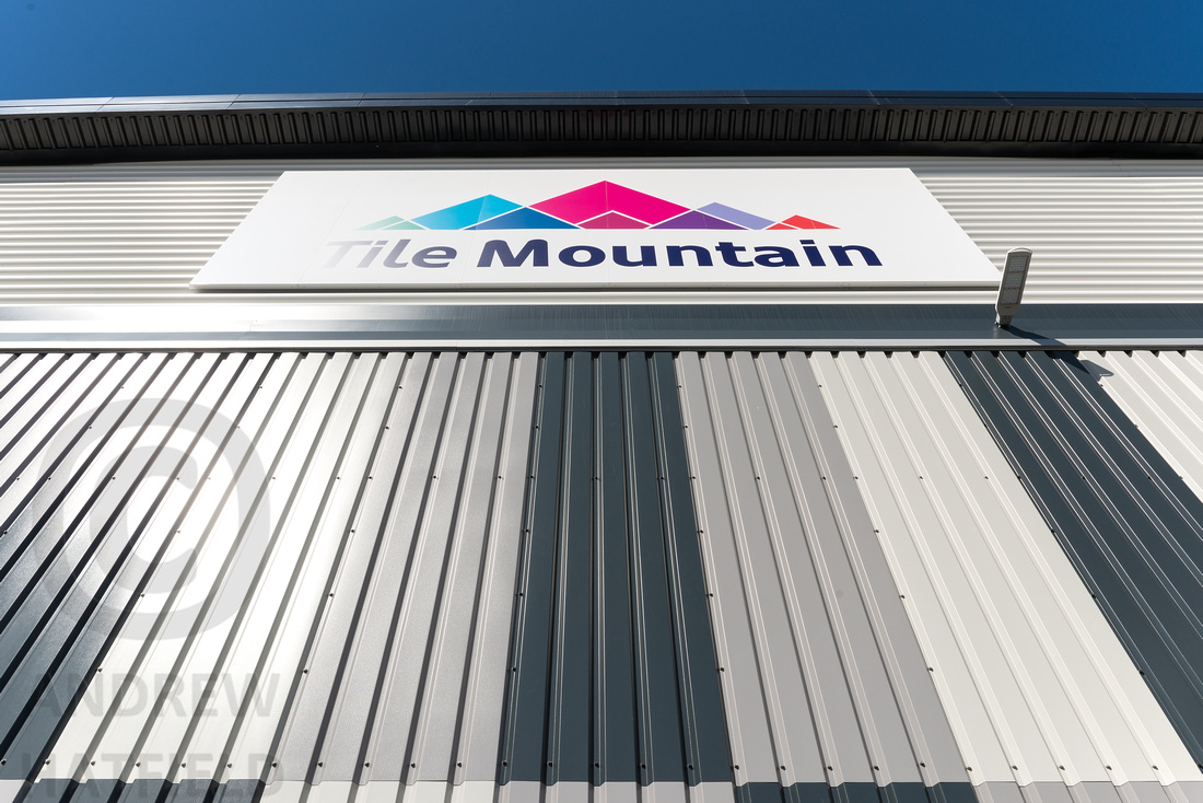 Tile Mountain sign high up on the side of the warehouse