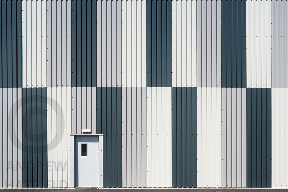 Monochrome chequered cladding on the side of warehouse 